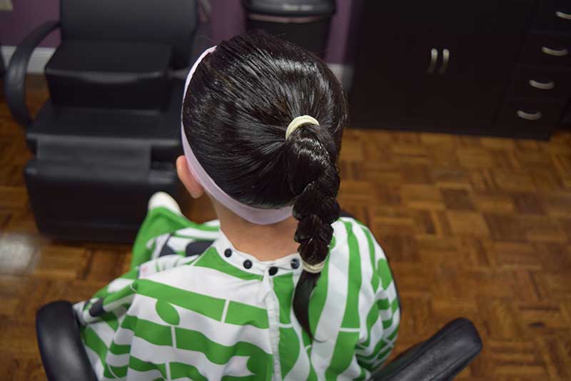 Girl getting a head lice treatment