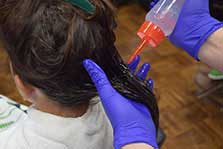 Girl Getting Oil In Her Hair After Head Lice Treatment
